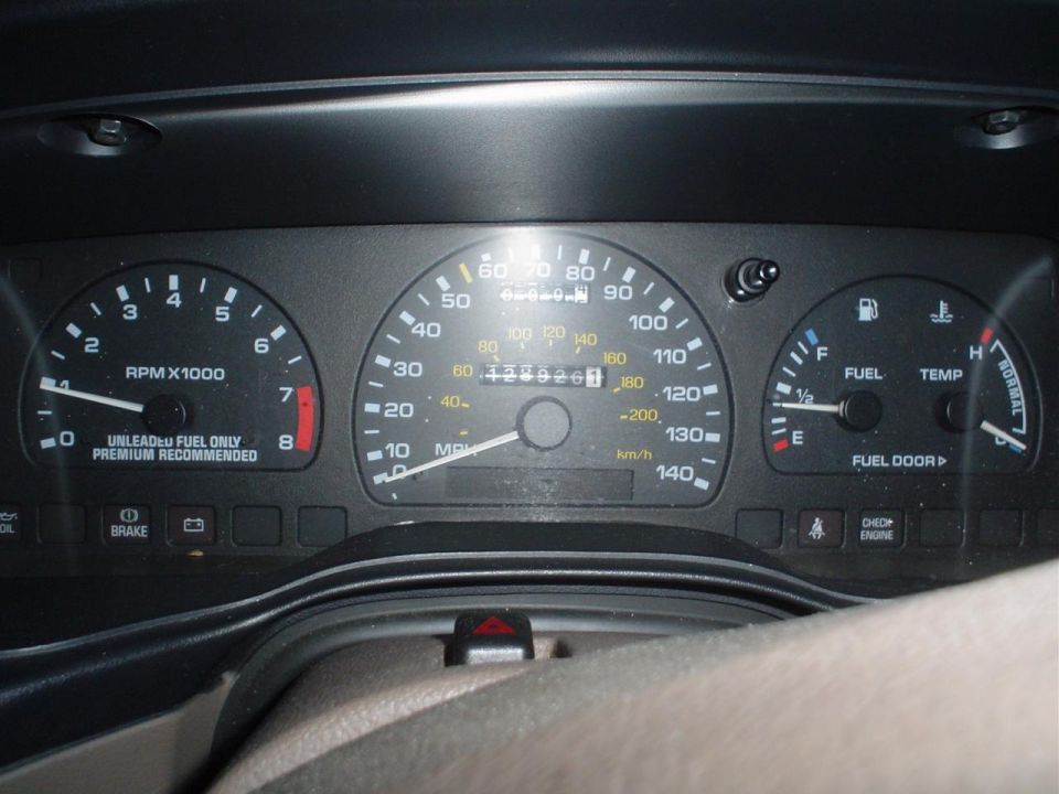 Dashboard gauges with illuminated needles and markings. Center console visible