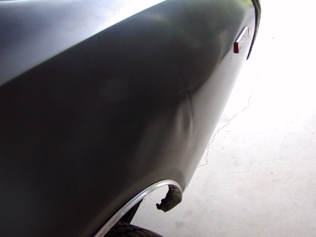 Dark fender with dent and chrome trim
