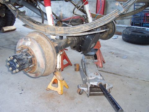1994 Ford F-150 - Close-up view of a vehicle's rear axle and suspension system supported by jack stands.