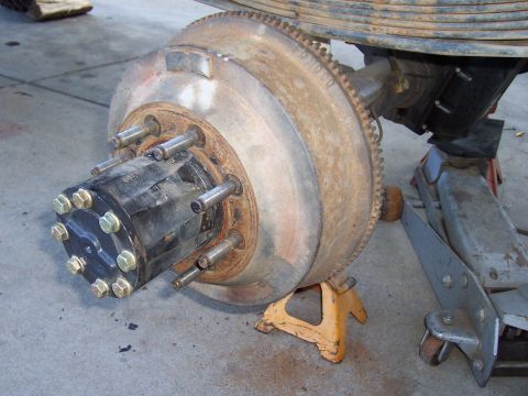 1994 Ford F-150 - Close-up view of a vehicle's rear axle hub and brake drum assembly, supported by jack stands.