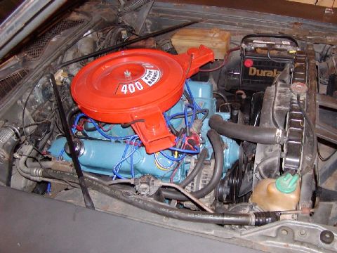 1988 Ford Bronco - The engine bay shows a blue engine block and an orange air cleaner assembly.