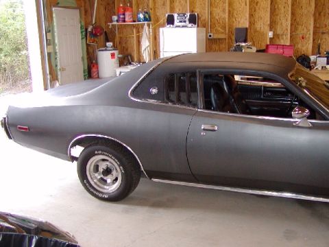 1988 Ford Bronco - Side view of a 1975 Dodge Charger parked in a garage.
