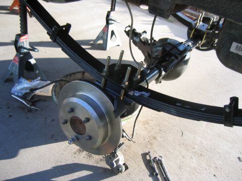 1997 Jeep Cherokee - Close-up of a vehicle's rear axle and suspension components being worked on.