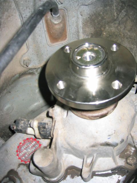 1997 Jeep Cherokee - Driveshaft flange installation on a vehicle's transfer case, a red sticker with text.