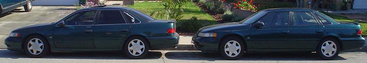Two 1995 Ford Tauruses parked side-by-side, dark green