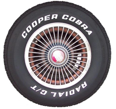 1985 Ford Crown Victoria LTD - A Cooper Cobra Radial G/T tire is mounted on a chrome wire wheel with a red center cap.
