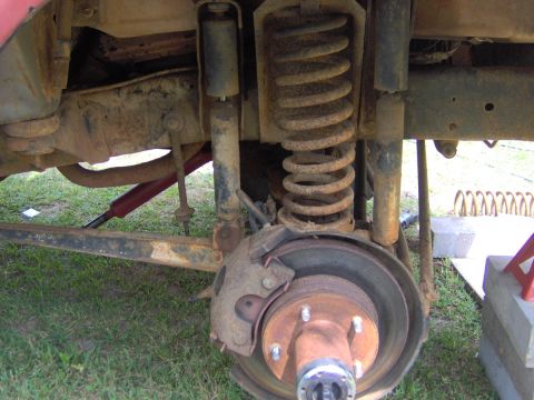 1979 Ford Bronco - Rear suspension components, including a coil spring and shock absorber, are shown in this close-up view.