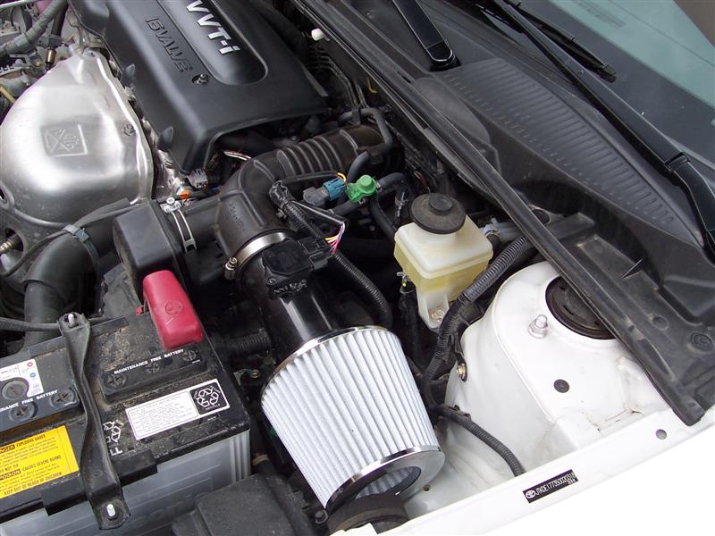 VVT-i engine bay with aftermarket cone air intake filter and red-top battery