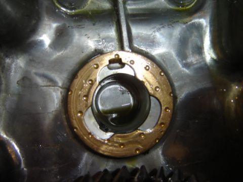 1992 Ford Bronco - Internal view of a vehicle's transfer case, focusing on a circular component with brass accents and visible oil.