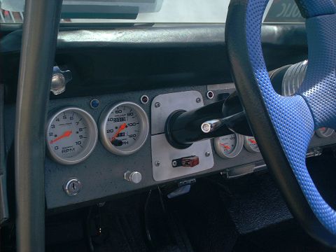 1990 Ford Bronco - Custom aluminum dash panel fitted with white-faced Auto Meter Pro-Comp tachometer and speedometer plus oil pressure and gauge cluster to th…