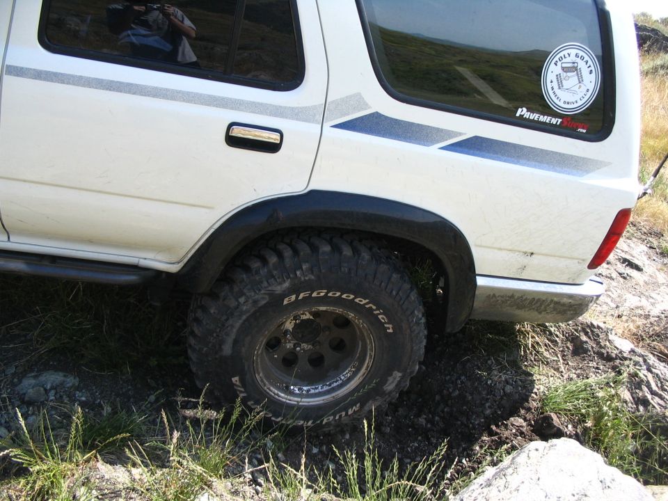Close-up of white Toyota rear quarter with BFGoodrich mud tire and Pavement Ends sticker
