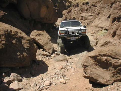 1997 Ford Ranger - A white 1997 Ford Ranger navigates a challenging, rocky canyon trail.