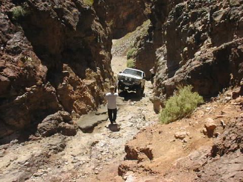 1997 Ford Ranger - A 1997 Ford Ranger navigates a narrow, rocky path in a desert canyon.