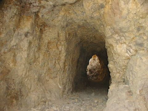 1997 Ford Ranger - A view into a rough-hewn mine tunnel, with light visible at the far end.