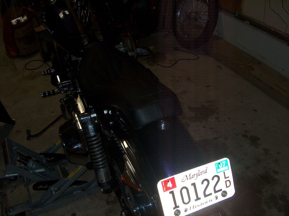 Rear of a motorcycle with Maryland license plate 10122 in a garage