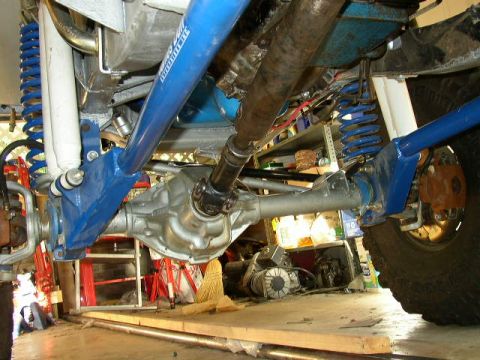 1995 Ford Bronco - Custom suspension parts, including a differential and driveshaft, are visible in this close-up shot.