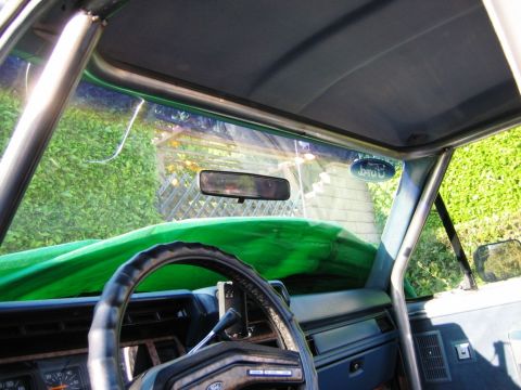1985 Ford Bronco - Interior view of a 1985 Ford Bronco, a custom roll cage and a visible Ford badge.