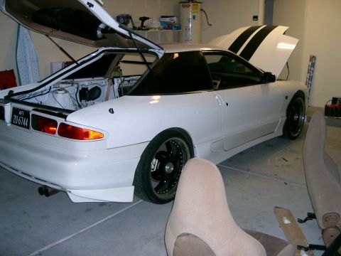 1996 Ford Probe - A white coupe with its hood and trunk open, revealing the engine bay and rear storage area.