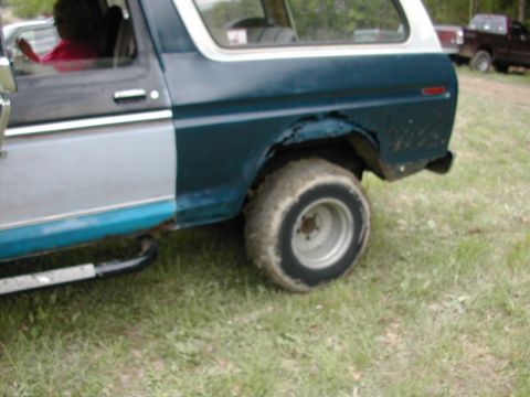 1979 Ford Bronco - Rear view of a 1978 Ford Bronco, showing rust damage and a side step.