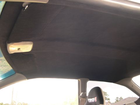 1997 Ford Probe - Interior view of a car's headliner and a racing seat with visible branding.