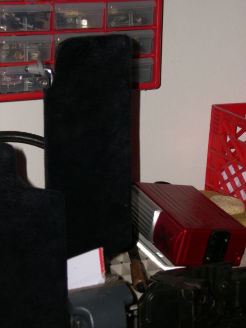 1997 Ford Probe - A black floor mat is positioned in front of a red storage organizer filled with small parts.
