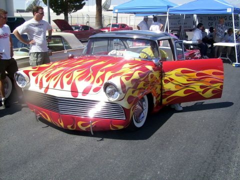 2002 Ford Mustang - Customized classic car with flame graphics displayed at an outdoor event.