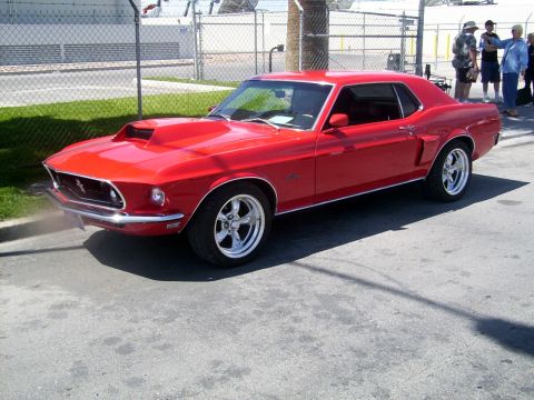 2002 Ford Mustang - This red 1969 Ford Mustang coupe is seen from a three-quarter front angle.