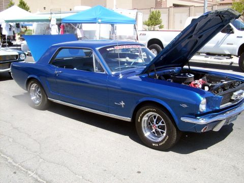 2002 Ford Mustang - A blue 1965 Ford Mustang coupe is displayed with its hood open, revealing the engine compartment.