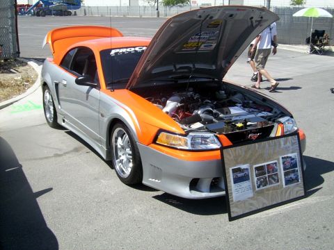 2002 Ford Mustang - Customized 2002 Ford Mustang on display at an event, with engine and trunk open.