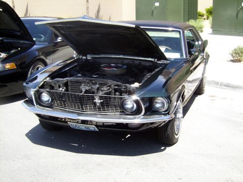 2002 Ford Mustang - Front view of a classic 1969 Ford Mustang, hood open, parked outdoors.