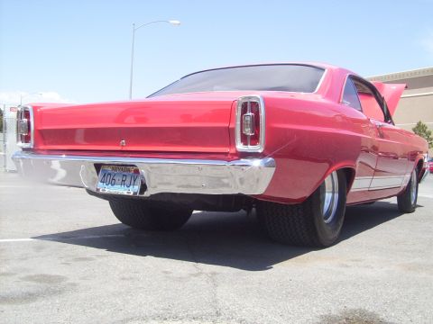 2002 Ford Mustang - A red 1967 Ford Fairlane is viewed from the rear, showing its classic body style and chrome accents.