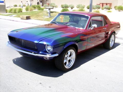 2002 Ford Mustang - This classic Ford Mustang features a unique custom paint job with flames and a two-tone color scheme.