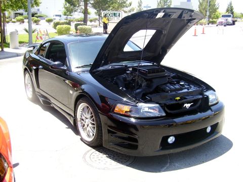2002 Ford Mustang - This black 2002 Ford Mustang is displayed with its hood open, revealing the engine compartment.