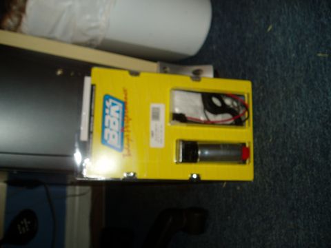 1990 Ford Bronco - A new fuel pump is shown in its original packaging, ready for installation.