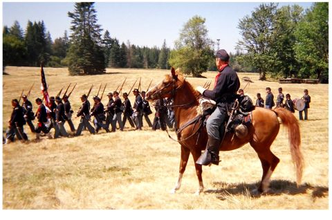1996 Ford Bronco - A Civil War reenactment features a cavalry officer on horseback observing a line of marching Union soldiers and a drummer boy in the backgr…
