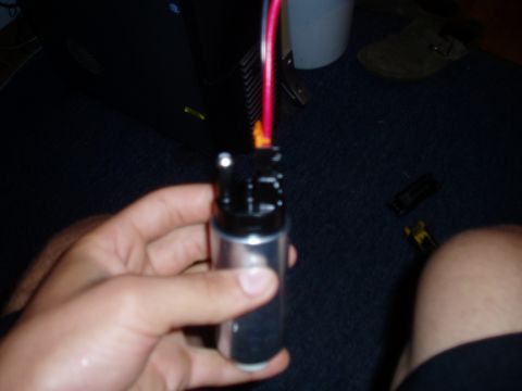 1990 Ford Bronco - Close-up of a fuel pump part being held in a hand.