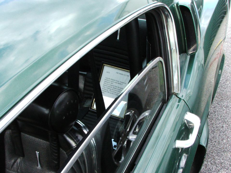 Interior view of a 1967 Shelby GT500 showing a framed document on the passenger seat