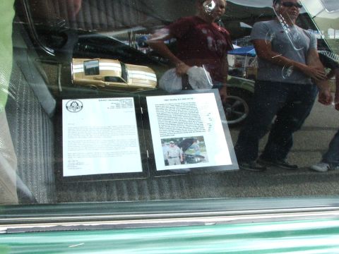 2005 Ford Mustang - A gold 1971 Ford Mustang model is displayed with informational documents.