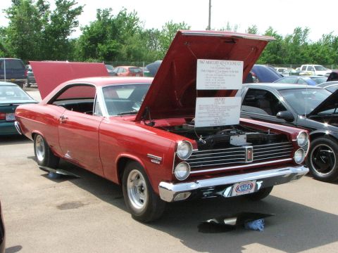 2005 Ford Mustang - A red 1967 Mercury Cyclone GT is displayed with its hood open, revealing the engine and historical information.