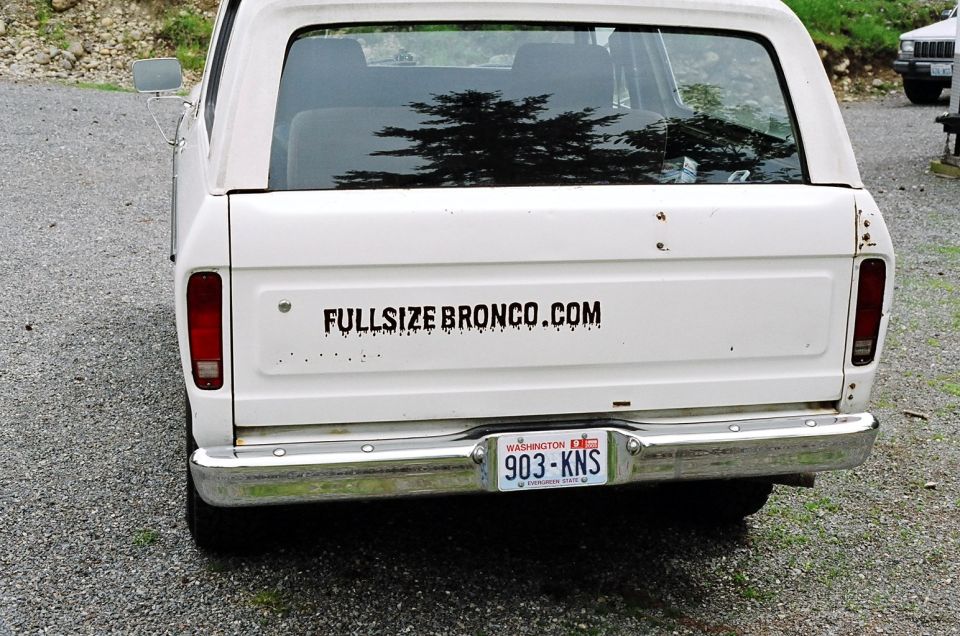 White 1978 Ford Bronco rear view, showing a "FULLSIZEBRONCO.COM" sticker and Washington license plate 903-KNS