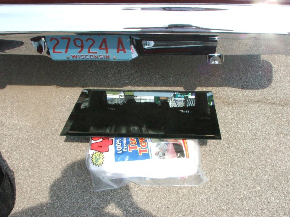 Rear bumper with Wisconsin license plate 27924 A and a piece of glass on towels