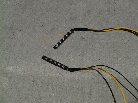 1999 Ford Taurus - Two LED light strips with wires are shown on a concrete surface.