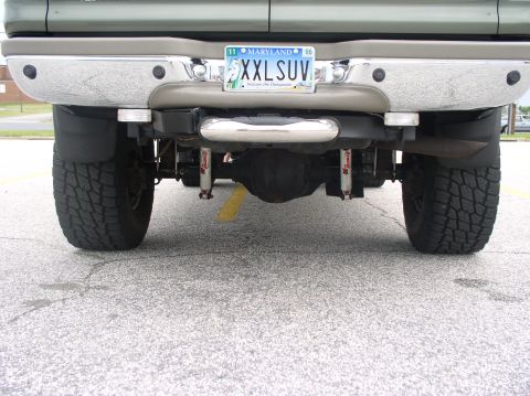 2000 Ford Excursion - This lifted SUV features a custom rear bumper and large tires, with a Maryland license plate indicating the year 2006.