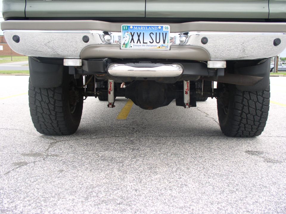 Rear undercarriage of green Ford SUV with Rancho shocks and 'XXLSUV' Maryland plate