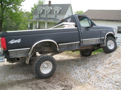 1979 Ford F-150 - This pickup truck has a "4x4" decal on the rear fender and "F-150" badging on the front fender.