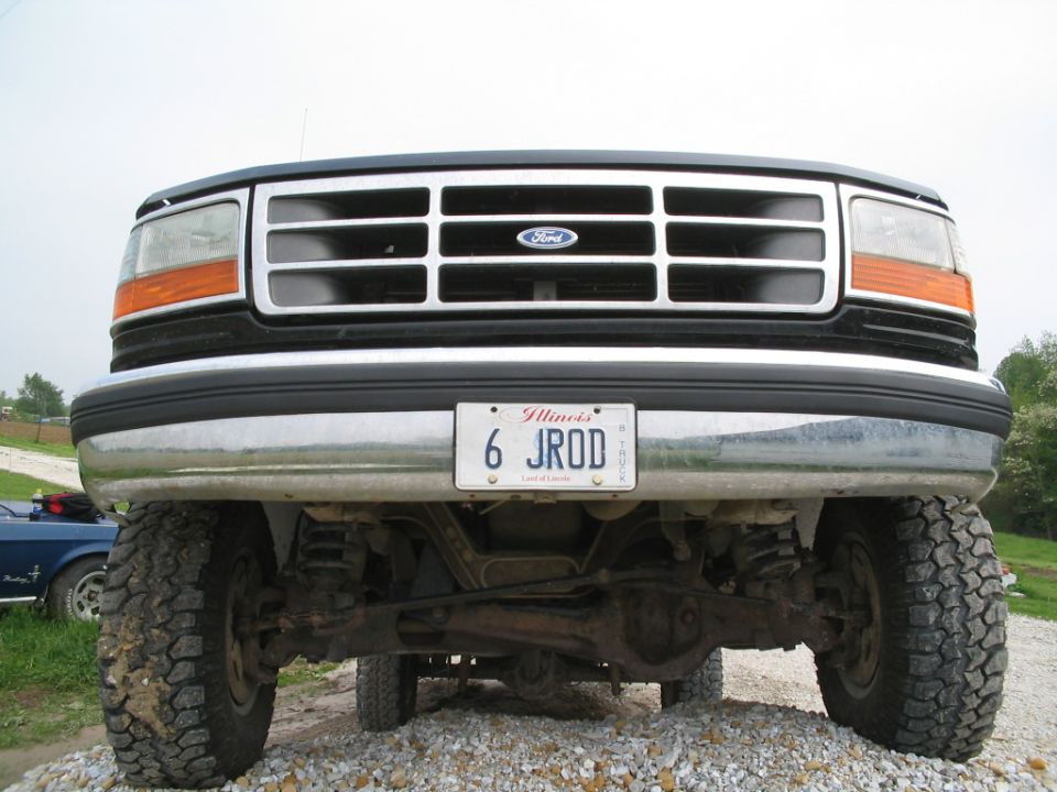 Front view of a Ford truck showing grille, headlights, bumper, and suspension components. Illinois license plate reads 6 JROD