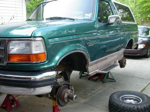 1996 Ford Bronco - This green 1996 Ford Bronco is up on jack stands, with its front wheels removed for maintenance.