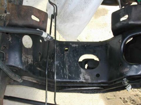 1994 Ford Bronco - This image shows a section of a vehicle's frame, likely from the front or middle, with various hoses and wiring visible.