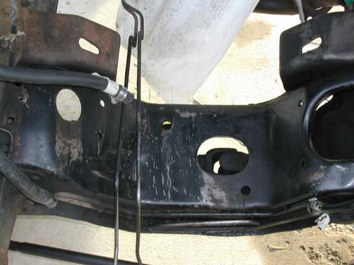 close-up of black metal frame with hoses and wires attached