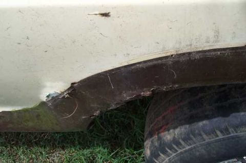 1979 Ford Bronco - The wheel well shows significant rust and damage, with a tire visible below.